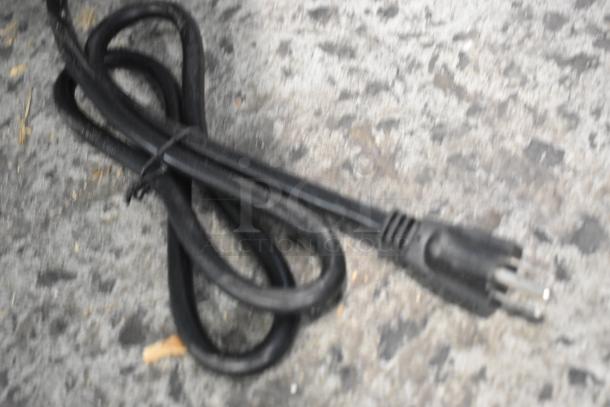 Black power cord for the Avantco 177STE3S stainless steel steam table, visible on a concrete surface.