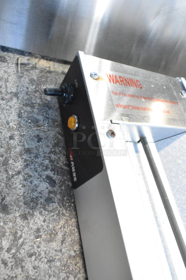 Brand new ServIt 423SW48THDBLA 48" double strip warmer, dual toggle controls, minor scratches, warning label visible.