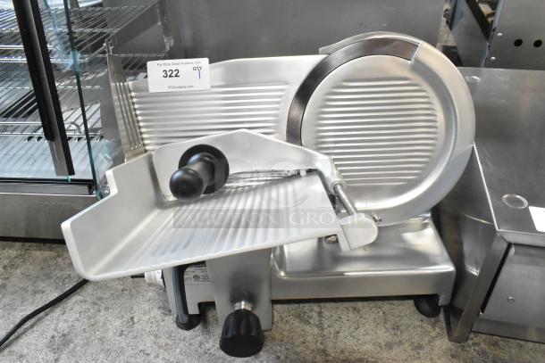 Brand new Bizerba GSE 12, 12" manual meat slicer, 2025 model, 120V, shows scratch and dent condition. Auction tag visible.