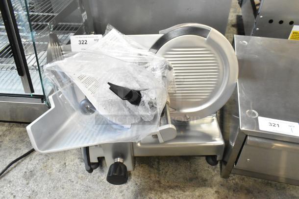 Brand new Bizerba GSE 12 slicer, 12" blade, manual gravity feed, 120V, 1 phase, minor scratches, protective wrap.