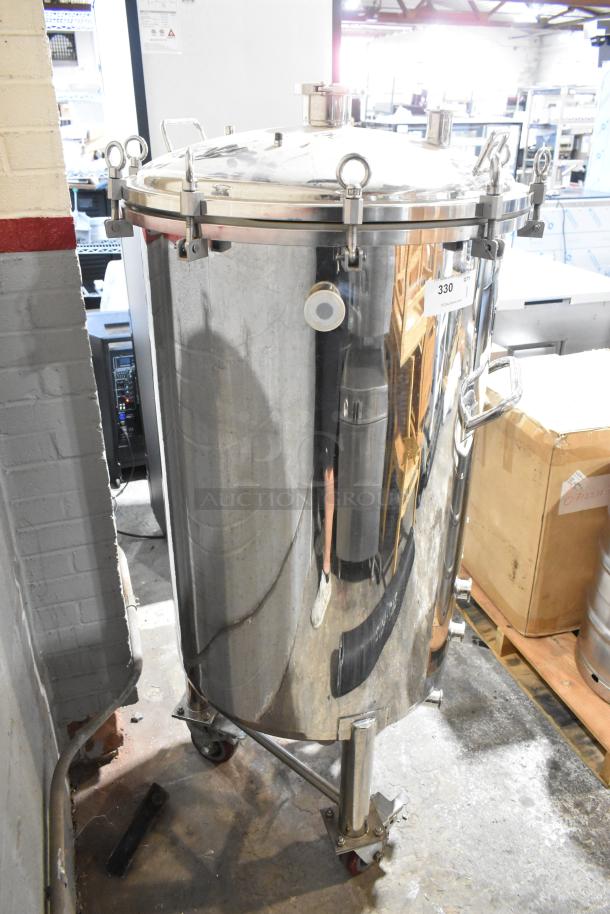 Stout 60-gallon stainless steel commercial kettle on casters. Lid with clamps, excellent condition. Auction tag visible.