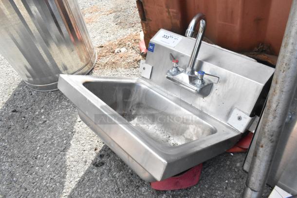 Stainless steel single bay sink with faucet and handles, minor wear, includes NSF tag indicating commercial suitability.