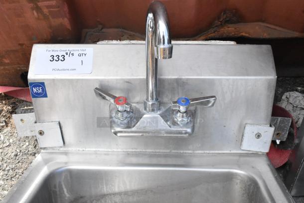 Stainless steel single bay sink with faucet, hot and cold handles; NSF-certified, minor wear, PCI Auctions tag visible.