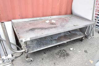 Stainless steel equipment stand with undershelf, commercial casters, visible wear and marks, item tag "335, Qty 1."