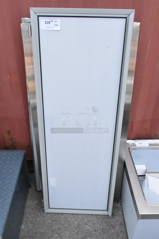 3 brand new scratch and dent items, including Watts WD-25 stainless steel doors, shown with protective frame and auction tag.