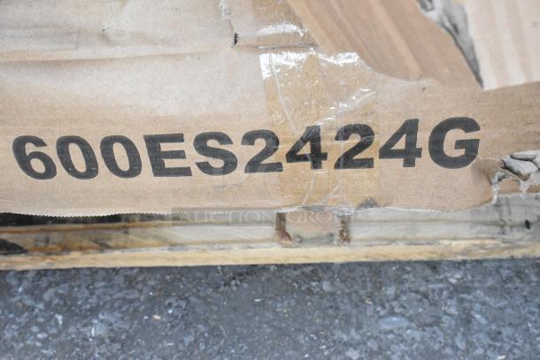 Cardboard box with label "600ES2424G," indicating stainless steel equipment, part of 18 scratch and dent items auction.