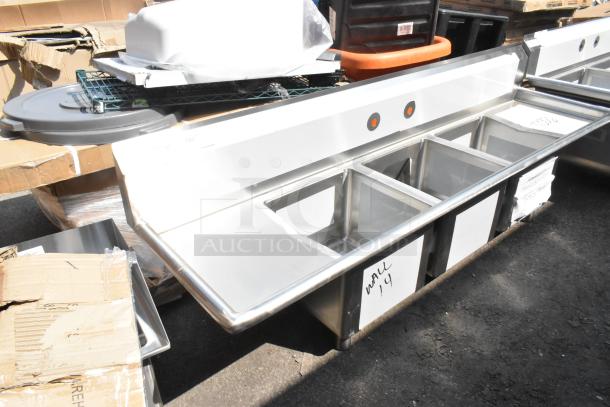 Brand new Regency 600S31515215 stainless steel 3 bay sink, dual drain boards, no legs, marked "WALL 4" on side.