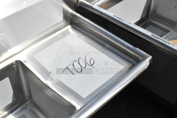 BRAND NEW SCRATCH AND DENT! Regency 600S31515215 Stainless Steel 3 Bay Sink with dual drain boards. No legs included. Visible markings: "T006."