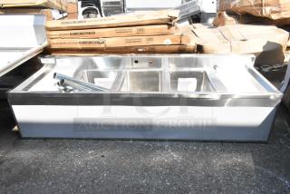 Brand new Regency 600B31014213 3-bowl underbar sink with two drainboards, 60"x18.75". Minor scratches and dents visible.