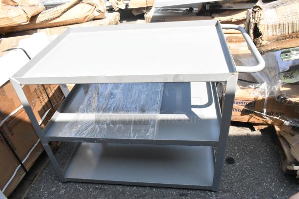 Brand new gray metal 3-tier cart with scratch and dent. Features three shelves, sturdy frame, and handle for mobility.