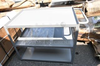 Brand new gray metal 3-tier cart with scratch and dent. Features three shelves, sturdy frame, and handle for mobility.