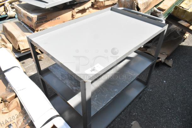 Brand new gray metal 3-tier cart with minor scratches and dents. Sturdy construction, ideal for versatile storage needs.