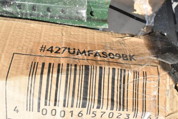 Cardboard box showing barcode and code #427UMFAS09BK, indicating scratch and dent items including an umbrella and tables.