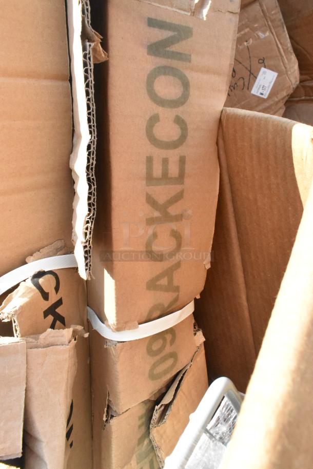 Cardboard boxes containing 14 brand new scratch and dent items, including grab bar and anti-fatigue floor mat. Marked "RACKECON."