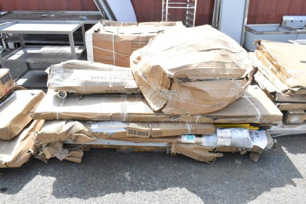 Brand new scratch and dent items including stainless steel overshelves and tables in damaged packaging on the ground.