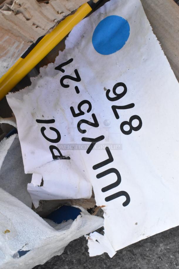 Torn label with printed text on damaged packaging, yellow tool visible. Items include stainless steel overshelves and tables.