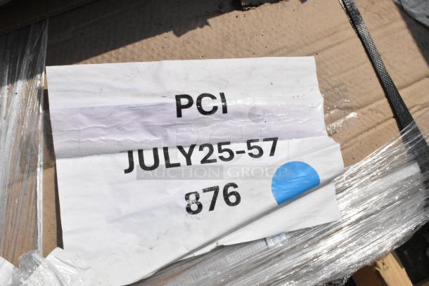 Cardboard box with label "PCI JULY25-57 876" and blue dot, wrapped in plastic, containing scratch and dent items.