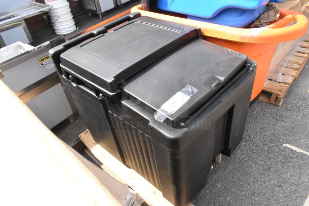 Black poly portable ice bin with commercial casters, brand new scratch and dent, visible tape indicating item number 363.