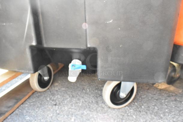 Black poly portable ice bin on commercial casters, scratch and dent condition, new. Blue drain valve visible.