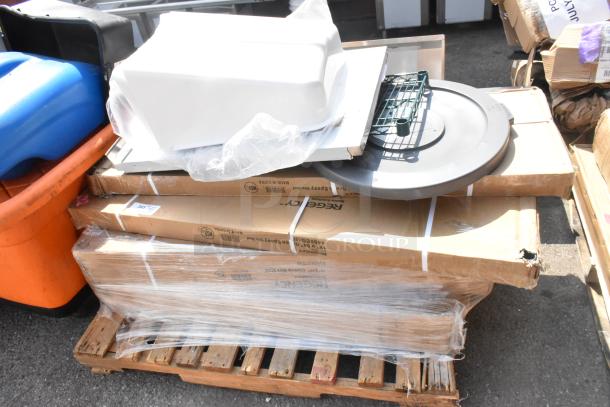 9 Brand New Scratch and Dent items including wire shelves on a pallet. Boxes show Reigency brand, visible packaging.