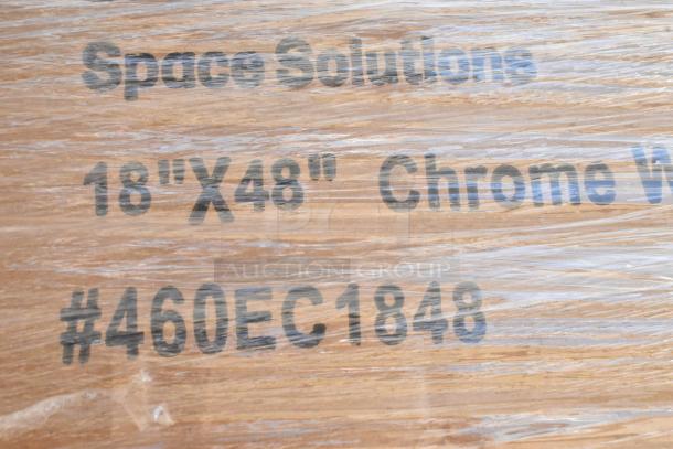 Alt text: Wrapped package labeled "Space Solutions 18" X 48" Chrome Wire Shelves #460EC1848," indicating new wire shelves.