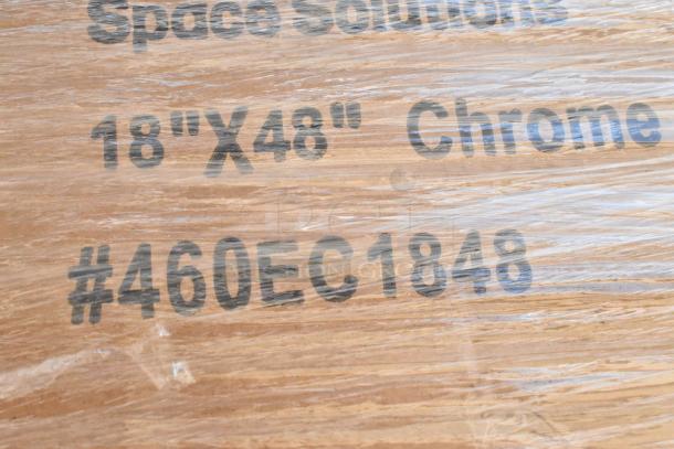Packaged wire shelves labeled “Space Solutions 18"x48" Chrome #460EC1848,” wrapped in protective plastic.