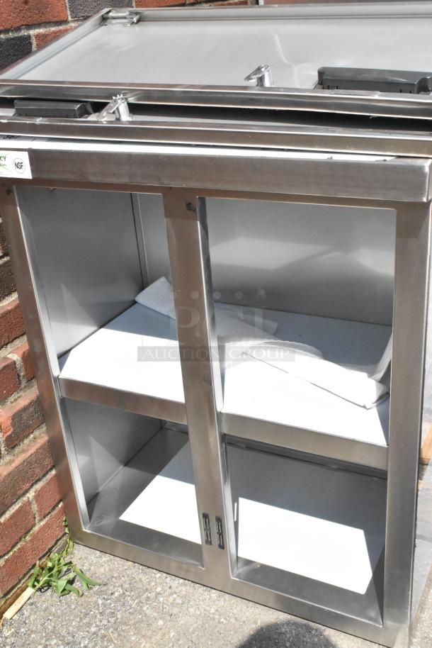 BRAND NEW SCRATCH AND DENT! Regency 600WCH1524 24" stainless steel wall cabinet with hinged doors, NSF sticker visible.