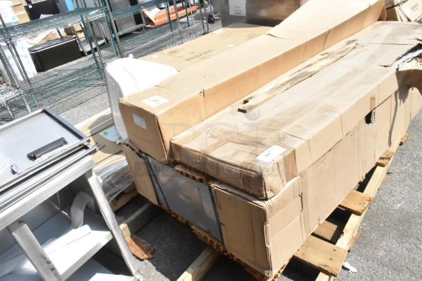 Three new scratch and dent Regency Locker Systems in cardboard boxes on wood pallets, slight box damage visible.