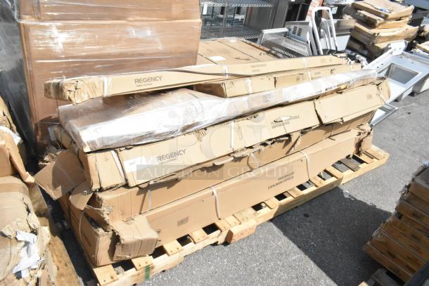 6 brand new scratch and dent Regency items on a pallet, including stainless steel over shelf and work tables in original boxes.