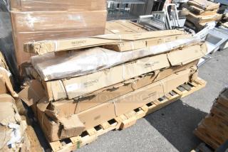 6 brand new scratch and dent Regency items on a pallet, including stainless steel over shelf and work tables in original boxes.