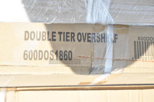 Cardboard box labeled "Double Tier Overshelf 600DOS1860," indicating one of six new scratch and dent stainless steel items for auction.