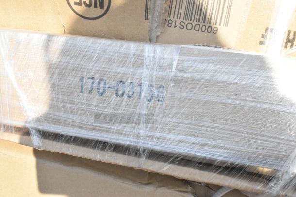 Packaged items with visible code "170-06156," indicating stainless steel overshelf and work tables, scratch and dent condition.