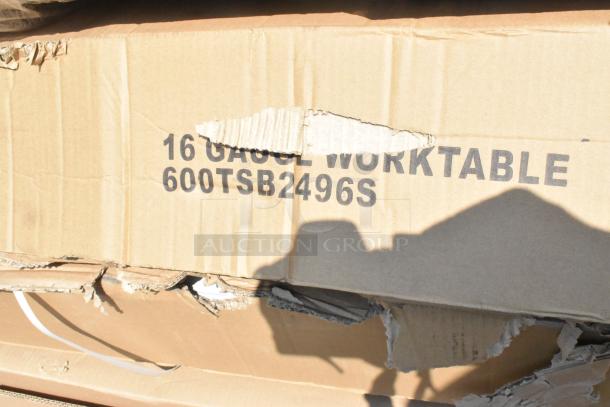 Cardboard box labeled "16 GAUGE WORKTABLE 600TSB2496S," showing signs of damage, contains new scratch and dent stainless steel items.