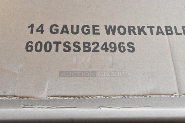 Cardboard box labeled "14 Gauge Worktable 600TSSB2496S," containing new stainless steel over shelf and work tables.