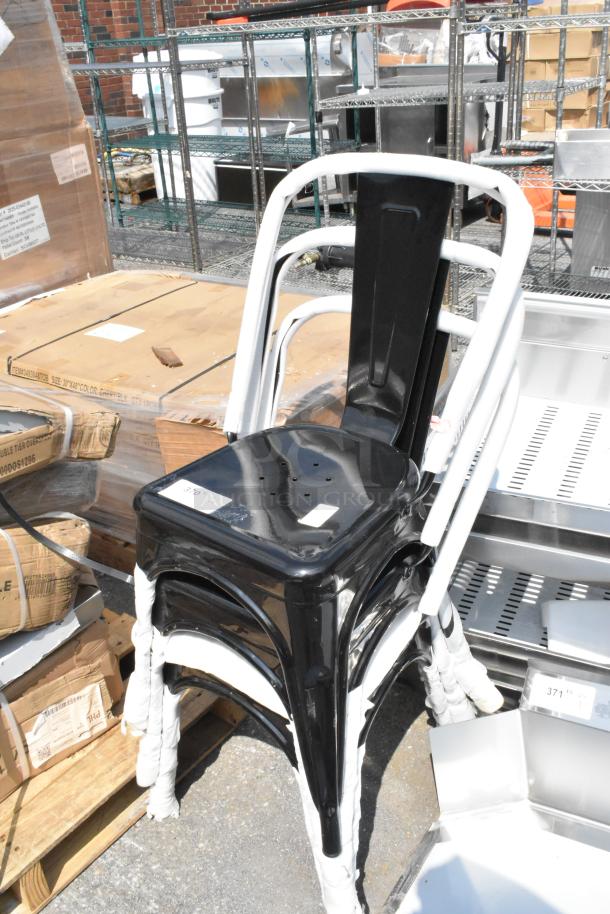 Three brand new black metal Tolix-style dining height chairs, scratch and dent condition, stacked with protective wrapping.