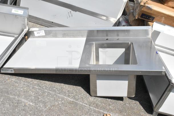 BRAND NEW Regency 600ST2448R 24"x48" stainless steel work table with sink, no legs, minor scratches, and dents, NSF certified.