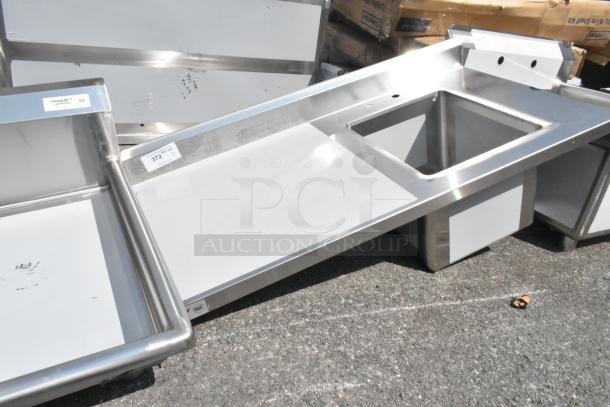 Brand new Regency 600ST2448R 24"x48" stainless steel work table with sink, scratch and dent, no legs, NSF label visible.