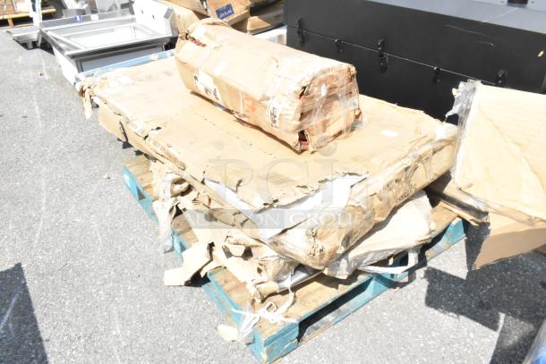 8 brand new scratch and dent items, including tabletop and stainless equipment stand, on a pallet with damaged packaging.