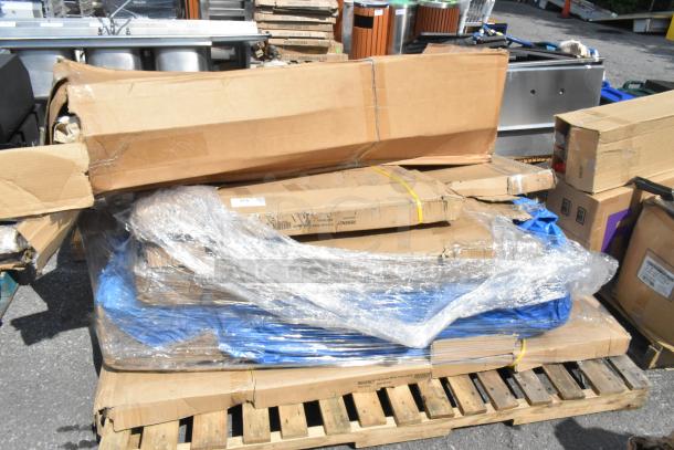6 brand new scratch and dent items including stainless tables and over shelf, wrapped and stacked on a pallet.
