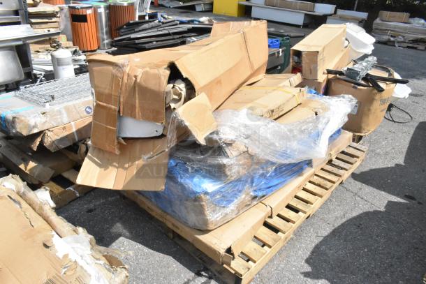Damaged packaging containing new scratch and dent stainless tables and over shelves on a pallet. Items offer 6 times bid value.