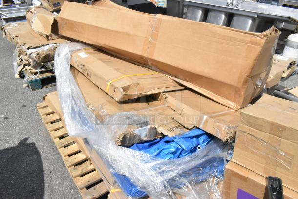 Pallet with new scratch and dent stainless tables and overshelf in damaged packaging. Includes six items per bid.