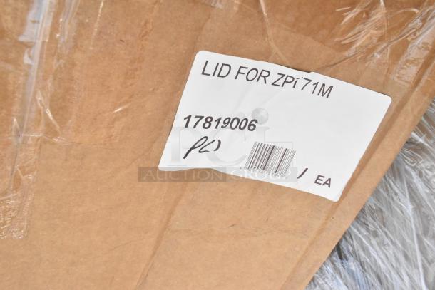 Label on cardboard box showing "LID FOR ZP171M" with code 17819006, part of auction lot including stainless tables.