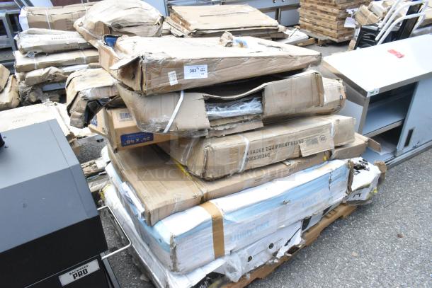 Damaged boxes of Backyard Pro items, including a stainless steel table, utility cart, and equipment stand. Model 554SMOKR60AS.