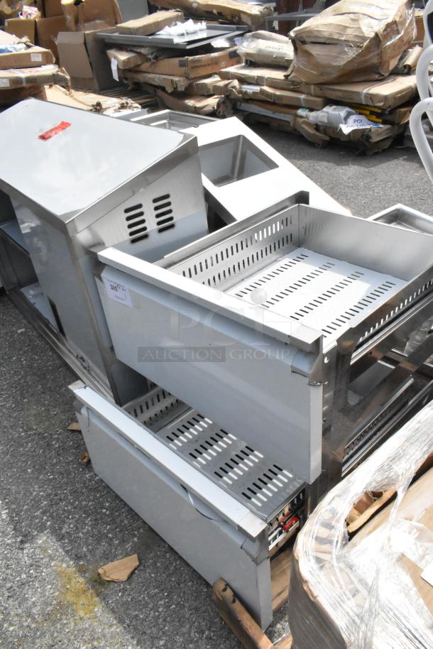 Brand new stainless steel drawers with minor scratches and dents, showing vented design, ready for auction.