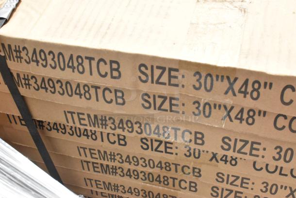 Cardboard boxes containing 12 new Lancaster Table & Seating 30" x 48" laminated reversible table tops. Model: 3493048TCB.