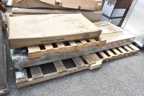 2 new scratch and dent items on pallet: 164DYMU Lancaster table dolly, 600TSB3096S Regency stainless steel work table in original packaging.