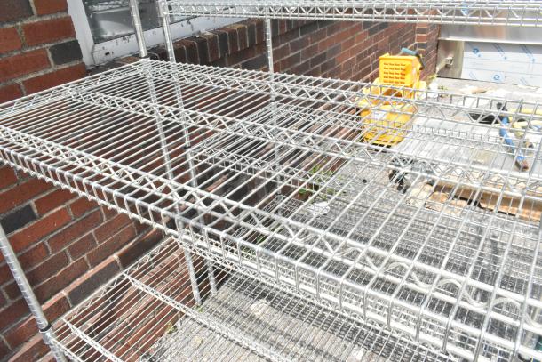 Chrome finish 5-tier wire shelving unit in used condition. Buyer must dismantle for shipping; freight charges apply.