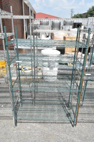 Metro green finish 4-tier wire shelving unit, sturdy, dismantle required, outdoors with visible use. Shipping not included.
