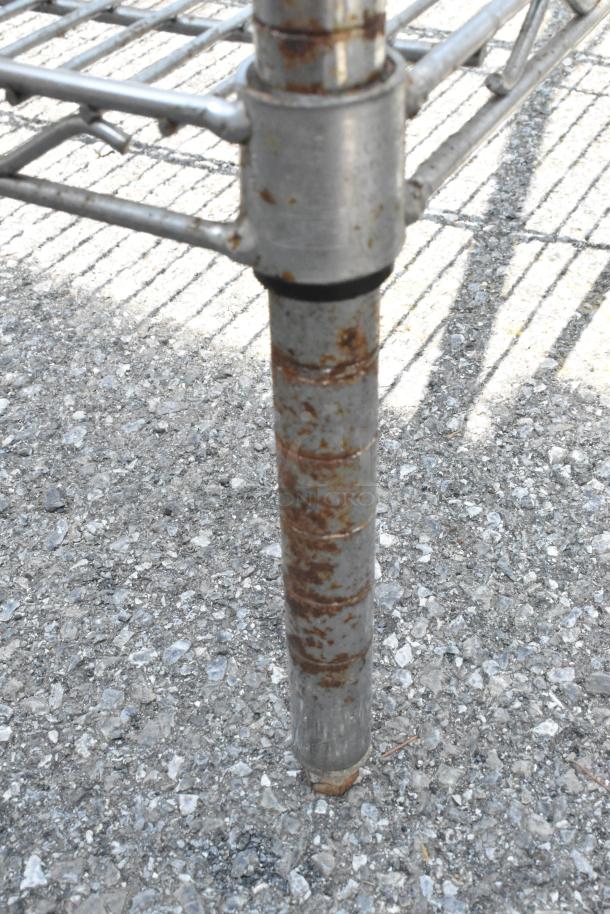 Metro chrome finish 3-tier wire shelving unit with visible rust on legs. Buyer must dismantle; consider freight charges.