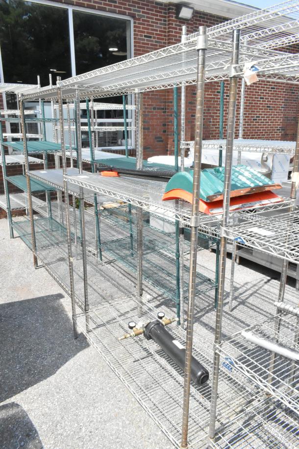 Metro chrome finish 3-tier wire shelving unit with contents including two snow shovels and a water filter. Buyer must dismantle.